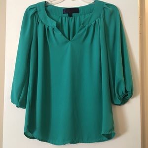 Loose, teal blouse.